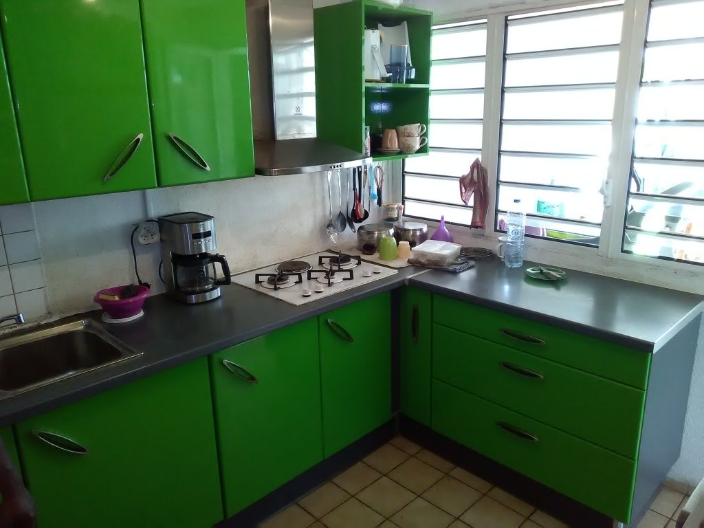 Cuisine en médium laqué de couleur verte et plan de travail postformé de couleur gris